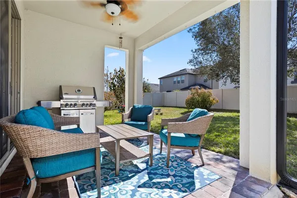 a view of a house with a yard and sitting area