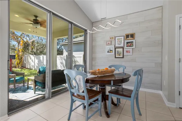 a living room with furniture kitchen view and a refrigerator