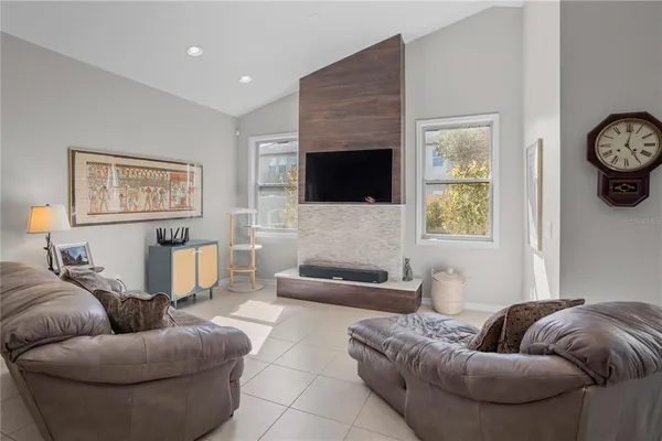 a living room with furniture and kitchen view