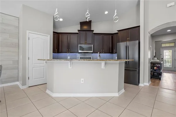 a kitchen with granite countertop stainless steel appliances and cabinets