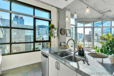 a kitchen with a large window and sink