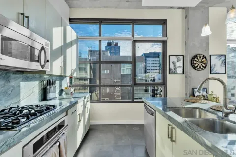 a kitchen with stainless steel appliances granite countertop a stove and a sink