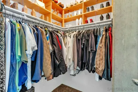a view of walk in closet with clothes
