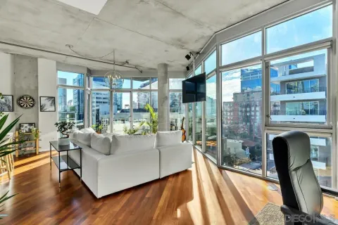 a living room with fireplace furniture and a large window