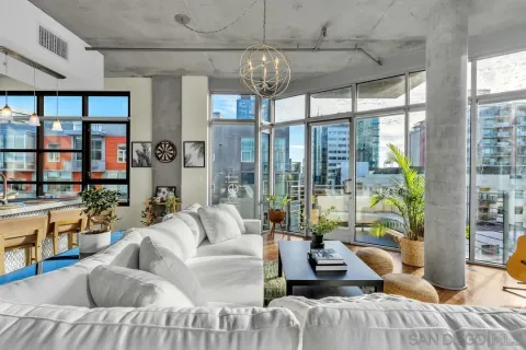 a living room with furniture and a chandelier