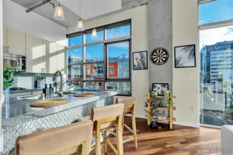 a dining room with furniture and a floor to ceiling window
