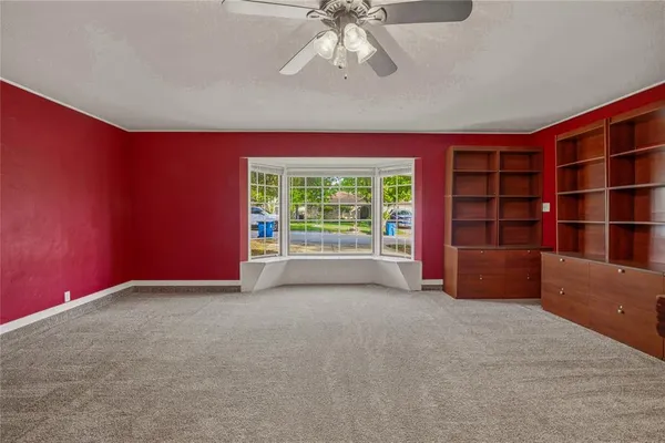 an empty room with furniture and a window