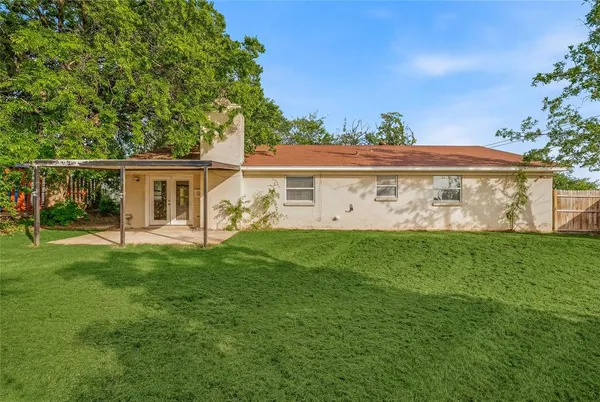 a view of a house with a yard and a porch