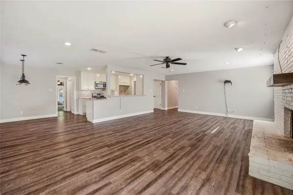 a view of a kitchen with a sink and wooden floor