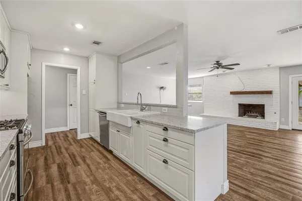 a spacious bathroom with a granite countertop sink mirror and a bathtub