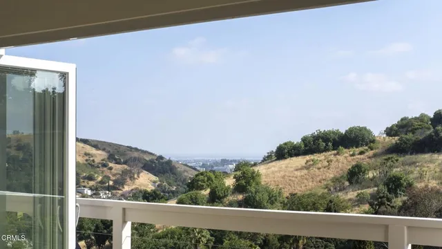 a view of a field with mountains in the background