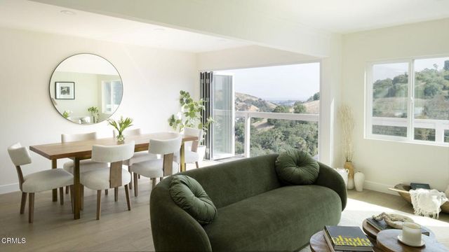 a living room with furniture and a floor to ceiling window