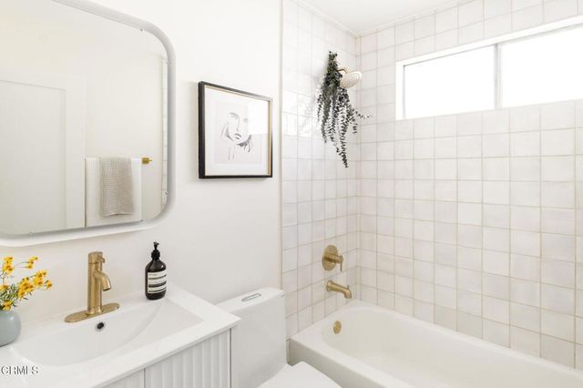 a bathroom with a sink vanity and a mirror