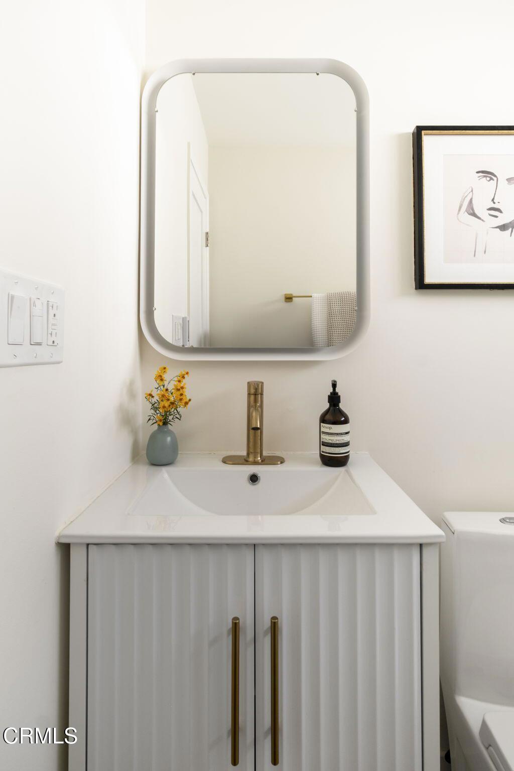 1158 Montecito Drive Los Angeles, CA 90031 - Photo 25 of 42 a bathroom with a sink vanity and a mirror
