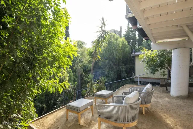 a backyard of a house with table and chairs