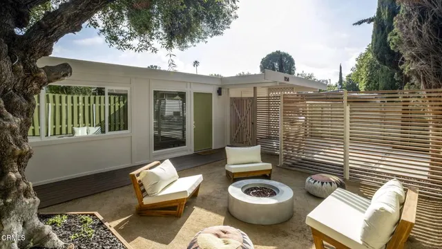 a view of a chair and tables front of the house