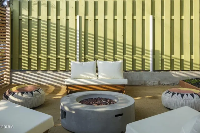 a view of a patio with a table and chairs