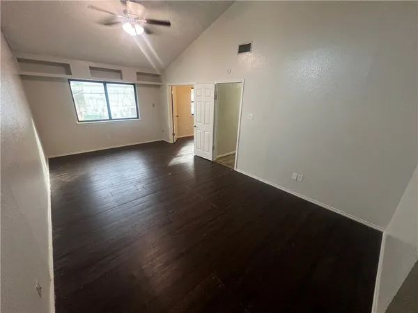 wooden floor in an empty room with a window