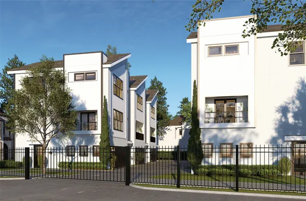 a front view of a house with a iron gate