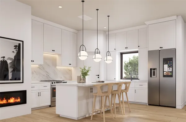 a kitchen with stainless steel appliances kitchen island granite countertop a table chairs and a refrigerator