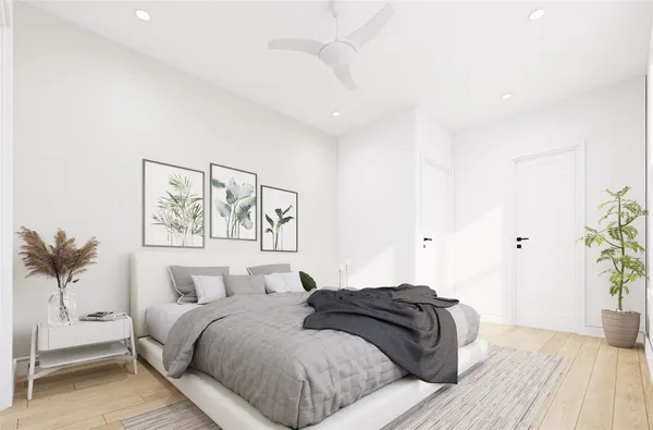 a bedroom with a bed and a painting on the wall