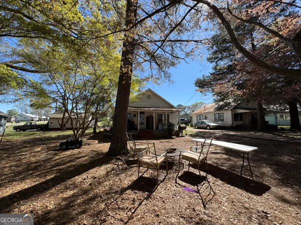 a wooden bench sitting in front of a house