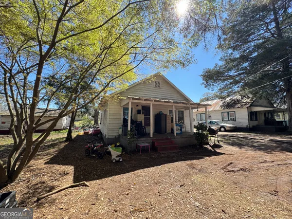 a view of a house with backyard porch and sitting area