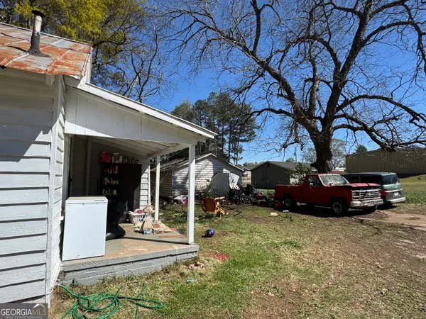 a view of a house with backyard porch and sitting area