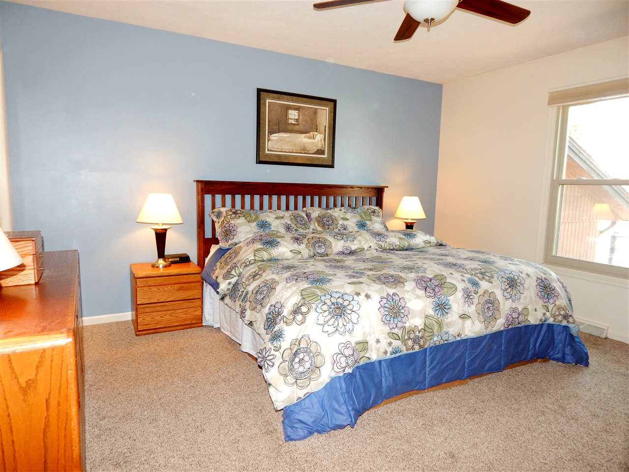 4456 Montclair Road Roscoe, IL 61073 - Photo 14 of 25 a bed sitting in a bedroom next to a window
