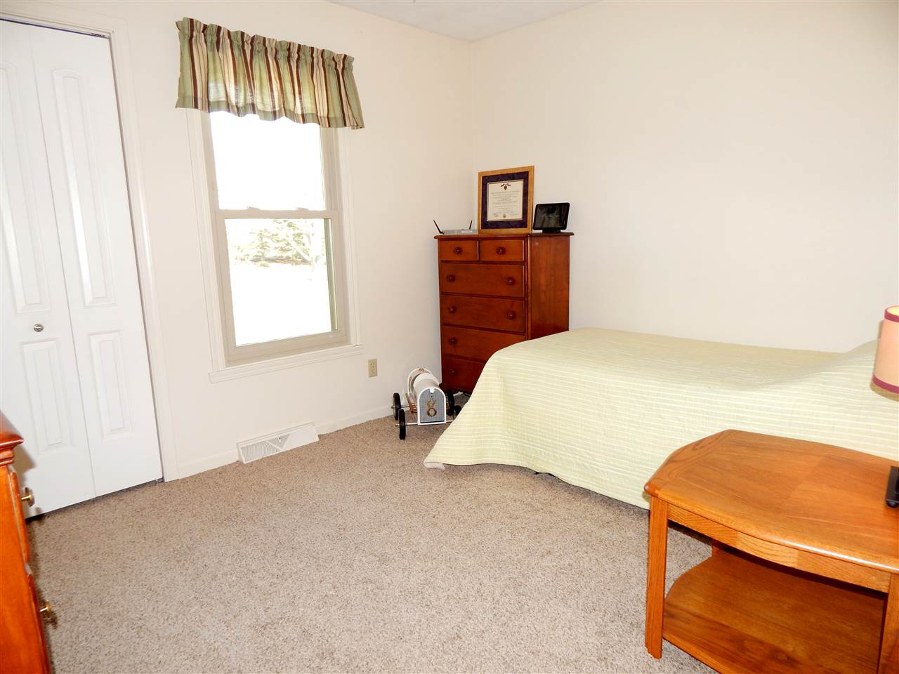 4456 Montclair Road Roscoe, IL 61073 - Photo 18 of 25 a bedroom with a bed and a painting on the wall
