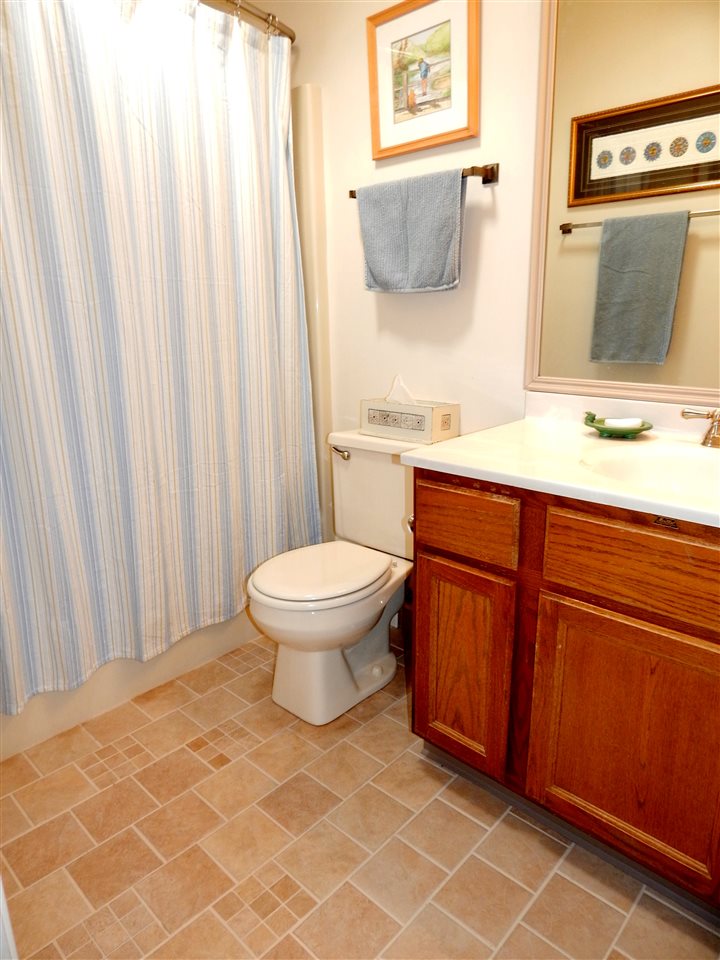 4456 Montclair Road Roscoe, IL 61073 - Photo 19 of 25 a bathroom with a toilet a sink and mirror