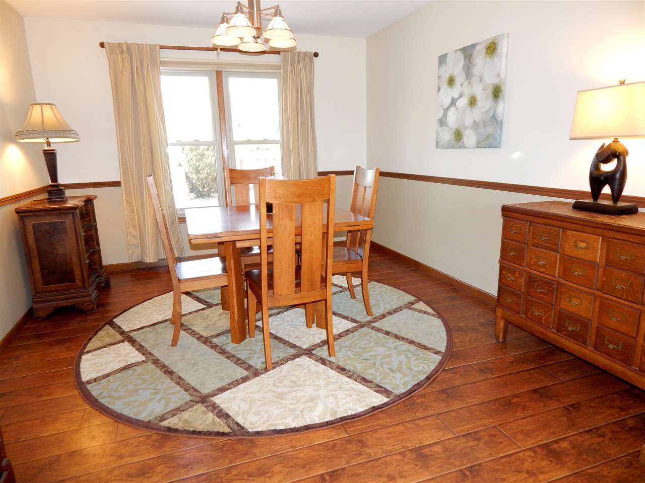 4456 Montclair Road Roscoe, IL 61073 - Photo 5 of 25 a dining room with wooden floor and a chandelier