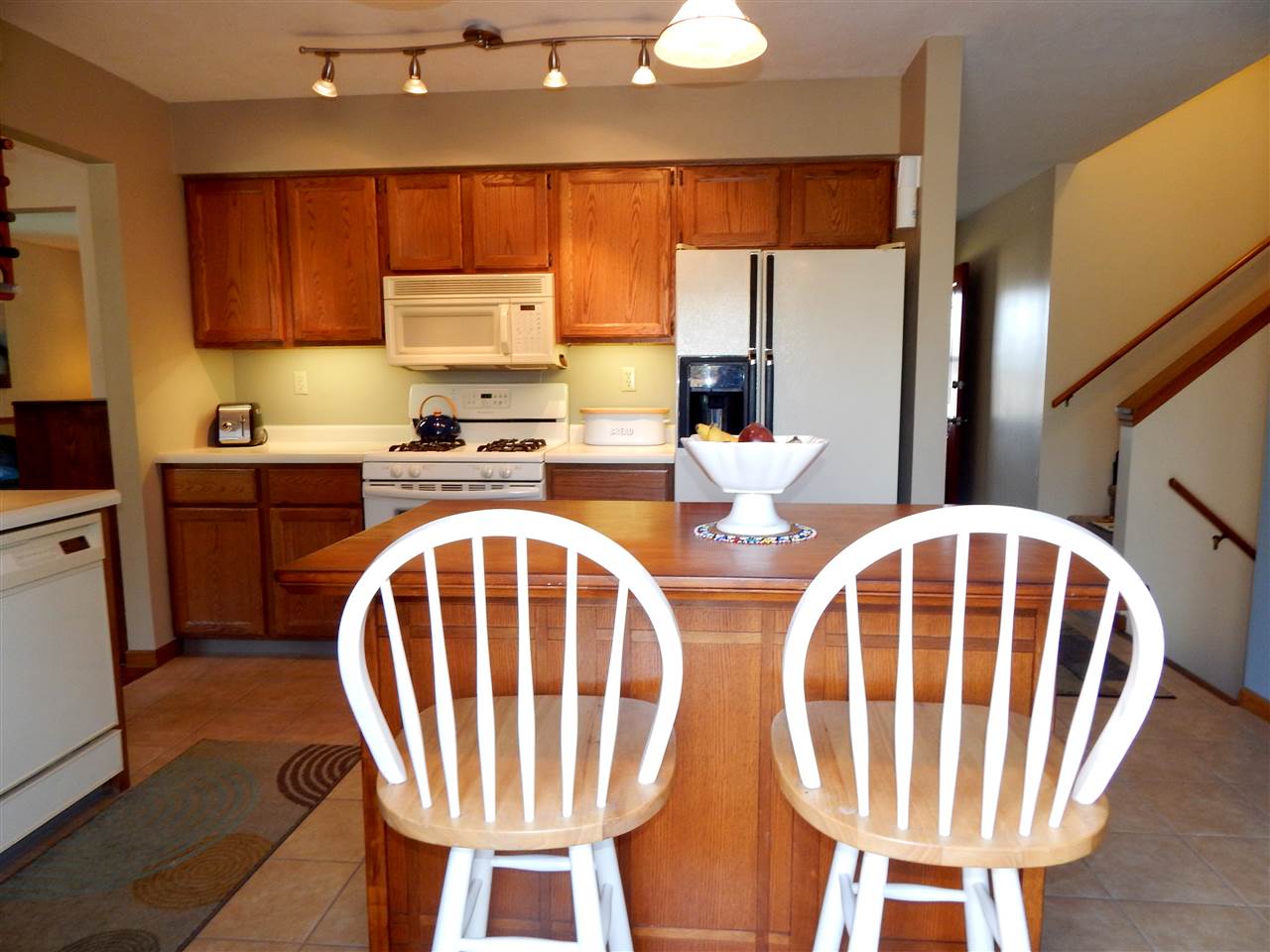4456 Montclair Road Roscoe, IL 61073 - Photo 7 of 25 a kitchen with stainless steel appliances a dining table chairs and a large window