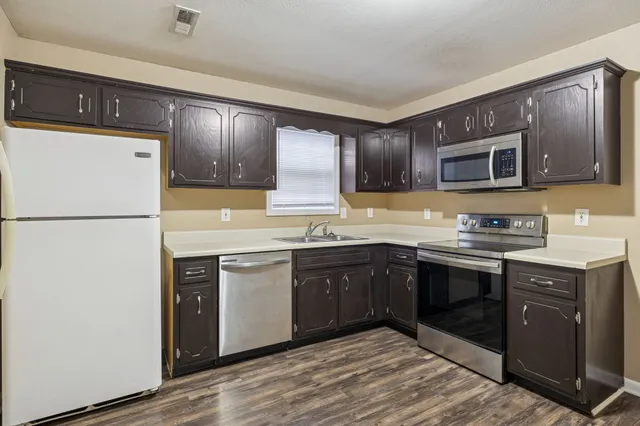 a kitchen with a refrigerator and a sink