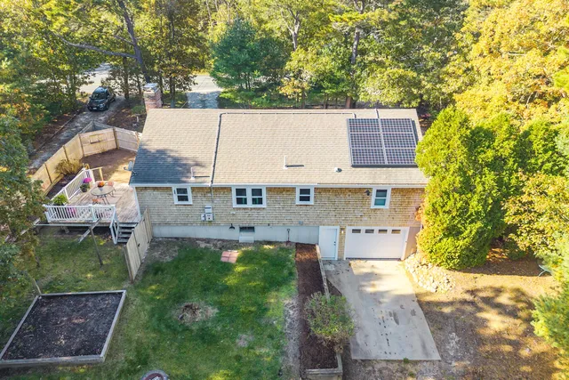 an aerial view of a house with a yard