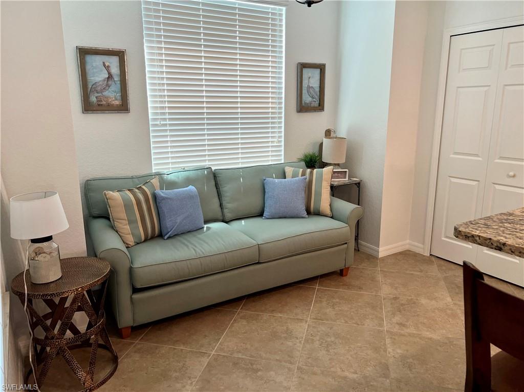 9518 Avellino Way, Unit 2313 Naples, FL 34113 - Photo 11 of 30 a living room with furniture and a window