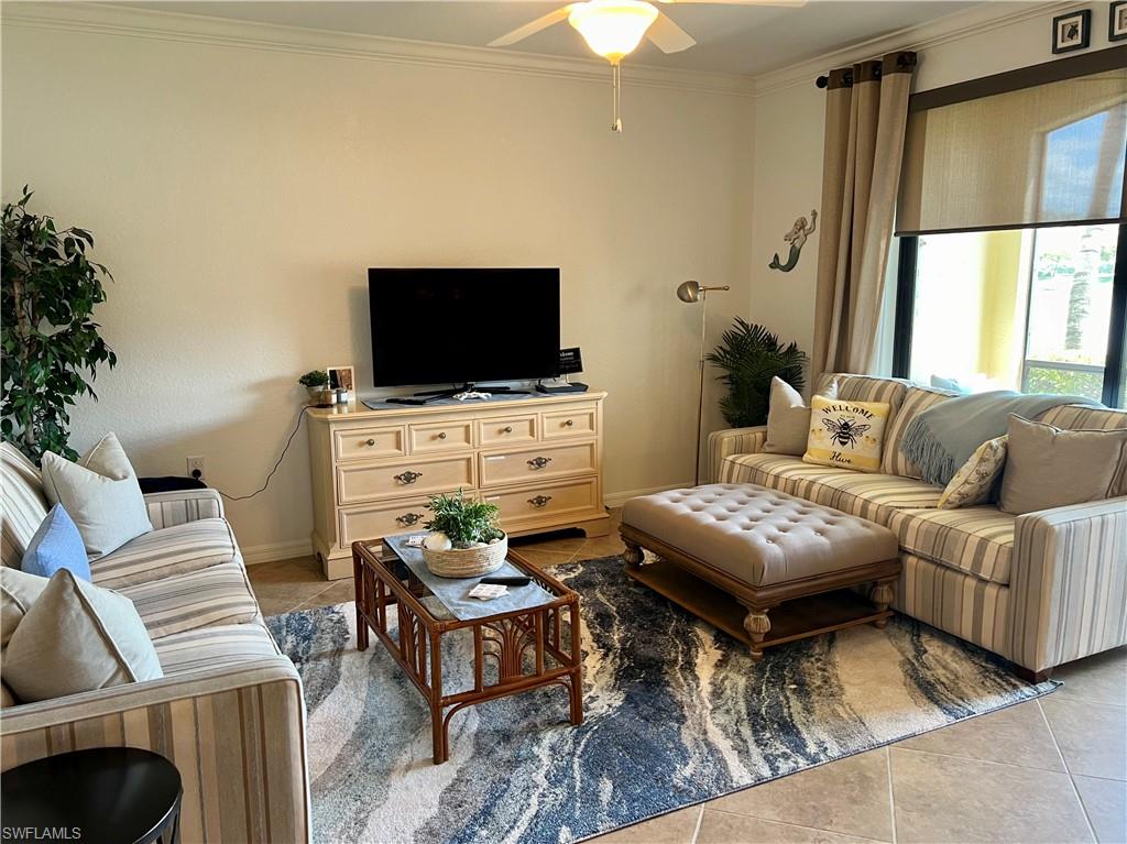 9518 Avellino Way, Unit 2313 Naples, FL 34113 - Photo 14 of 30 a living room with furniture and a flat screen tv