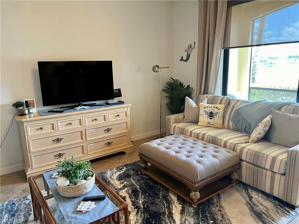 9518 Avellino Way, Unit 2313 Naples, FL 34113 - Photo 16 of 30 a living room with furniture and a flat screen tv