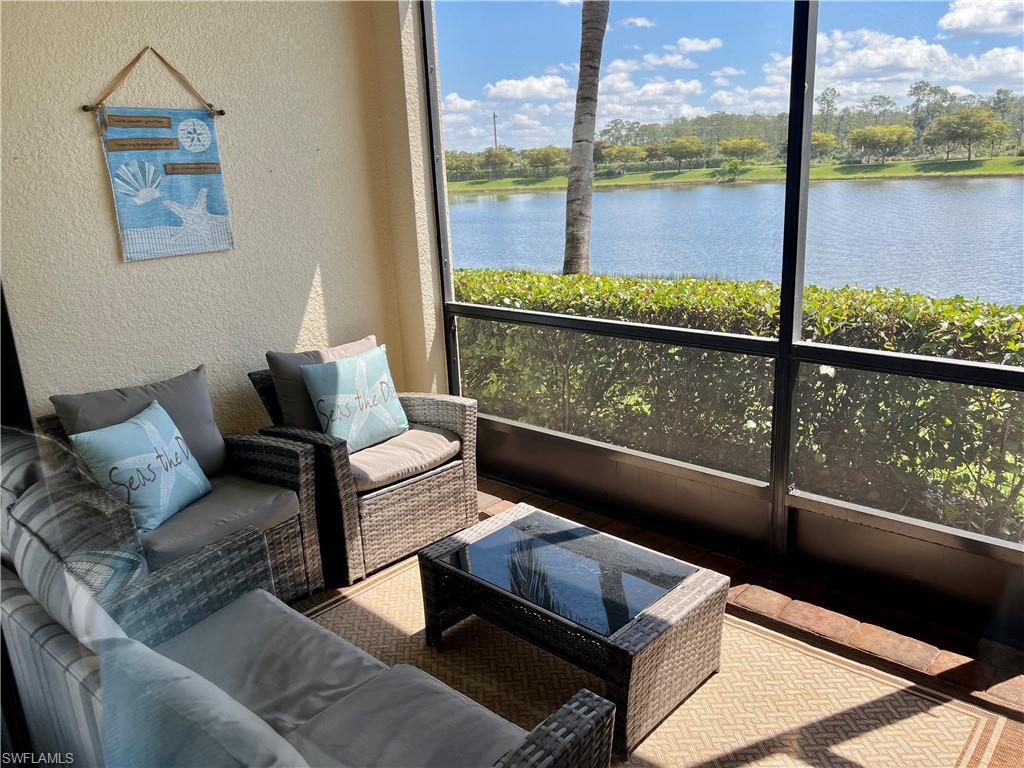 9518 Avellino Way, Unit 2313 Naples, FL 34113 - Photo 20 of 30 a living room with furniture and a floor to ceiling window