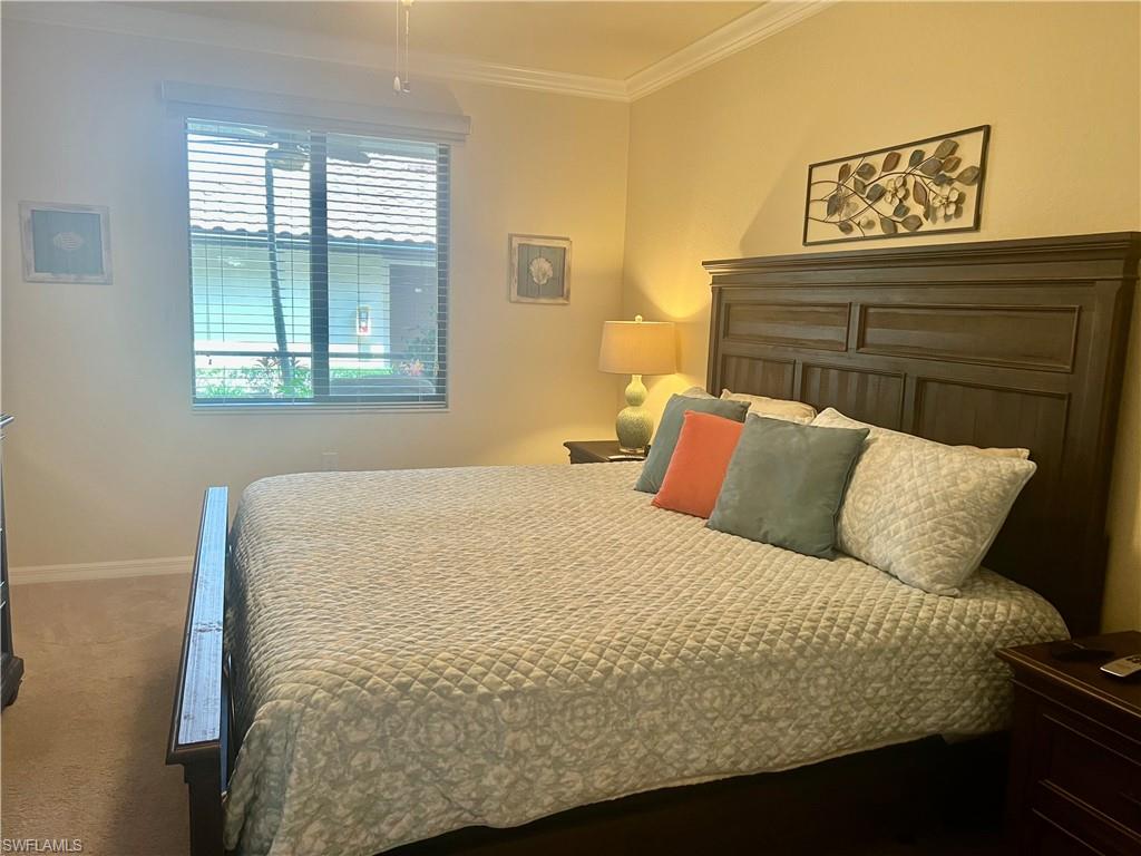 9518 Avellino Way, Unit 2313 Naples, FL 34113 - Photo 24 of 30 a bed sitting in a bedroom next to a window