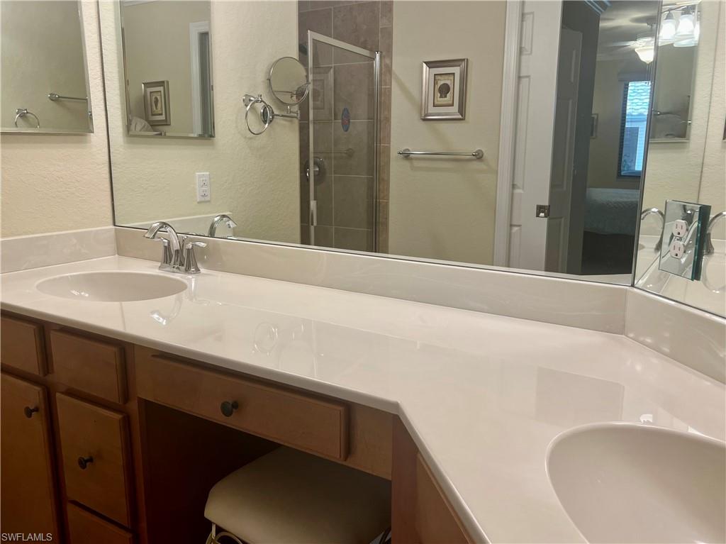 9518 Avellino Way, Unit 2313 Naples, FL 34113 - Photo 25 of 30 a bathroom with a sink and a mirror