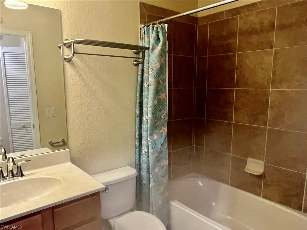 9518 Avellino Way, Unit 2313 Naples, FL 34113 - Photo 28 of 30 a bathroom with a shower toilet and sink