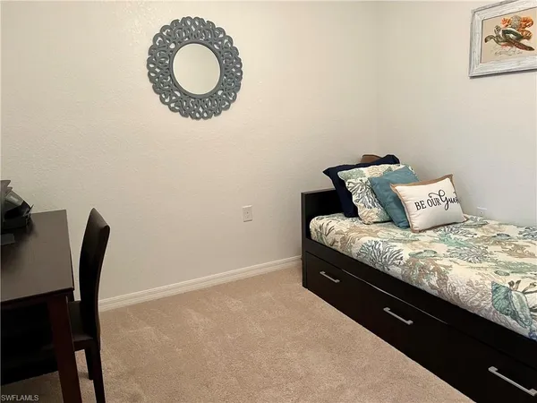 a bedroom with a bed and a chair