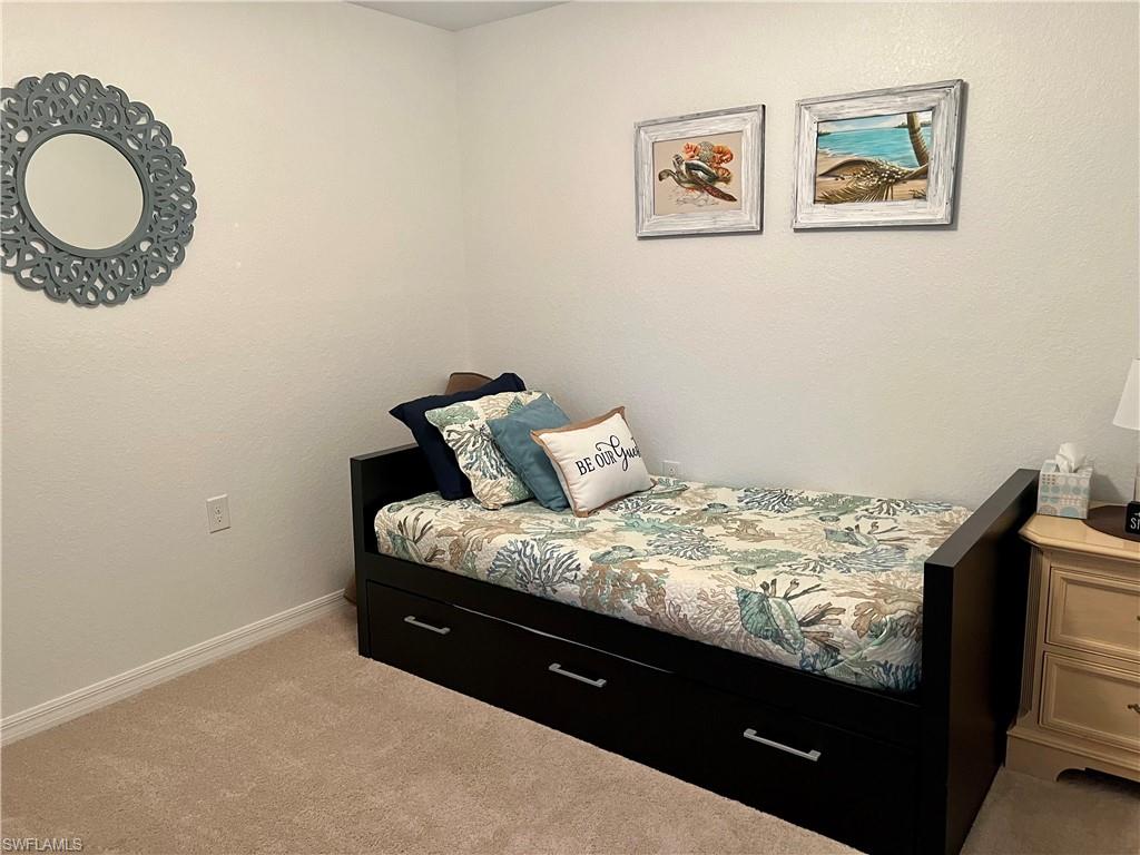 9518 Avellino Way, Unit 2313 Naples, FL 34113 - Photo 30 of 30 a bed sitting in a bedroom next to a window