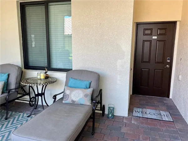 a balcony with table and chairs