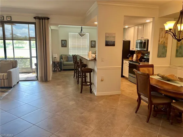 a view of a dining room with furniture and a large window