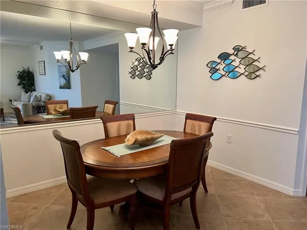 a dining room with furniture and chandelier