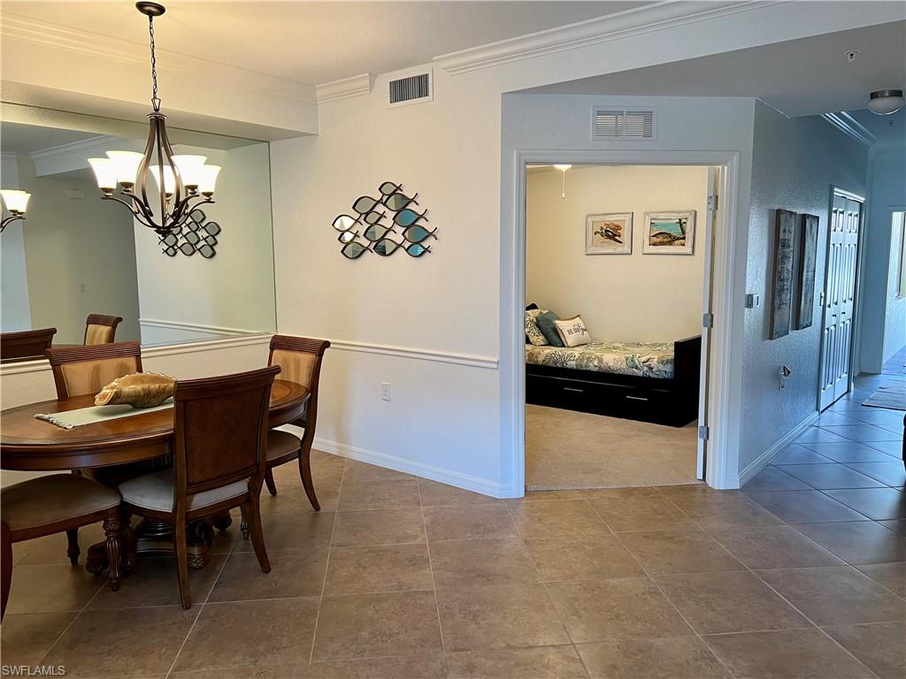9518 Avellino Way, Unit 2313 Naples, FL 34113 - Photo 9 of 30 a view of a dining room with furniture and wooden floor