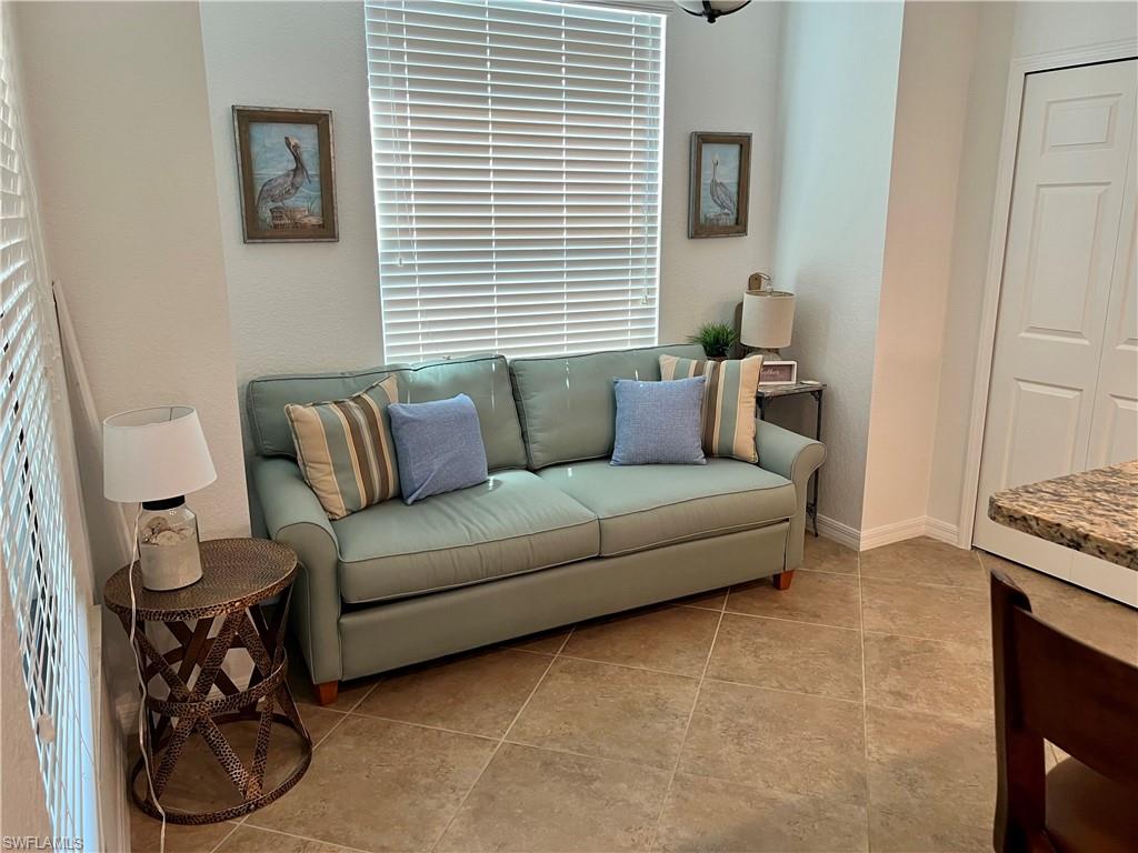 9518 Avellino Way, Unit 2313 Naples, FL 34113 - Photo 10 of 30 a living room with furniture and a window