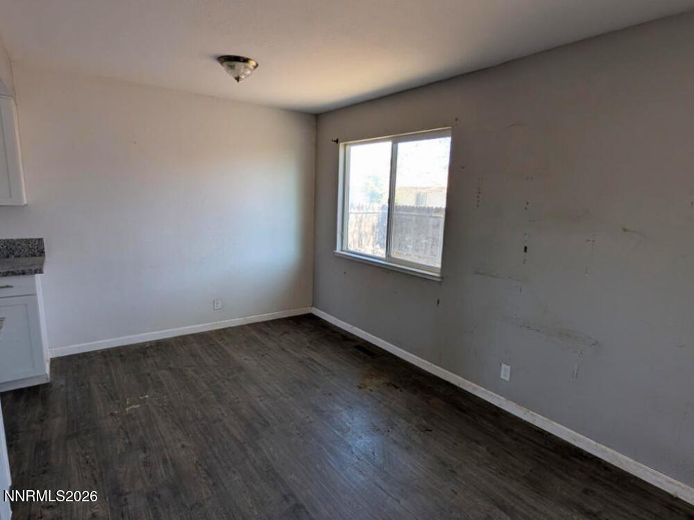 848 C Street Fernley, NV 89408 - Photo 4 of 15 an empty room with wooden floor and windows